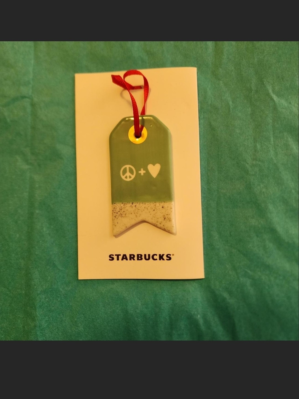 Starbucks green ceramic ornament with white peace sign and heart symbols